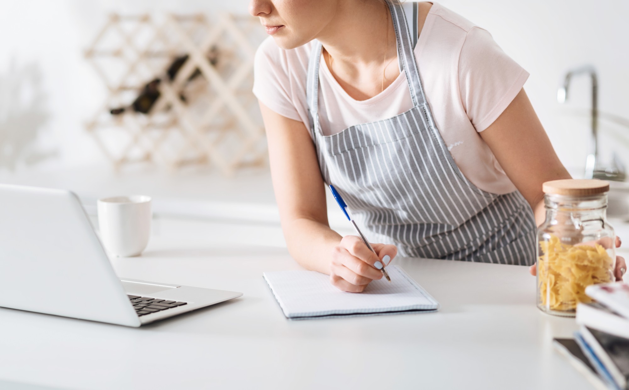 Technical writer taking notes in kitchen